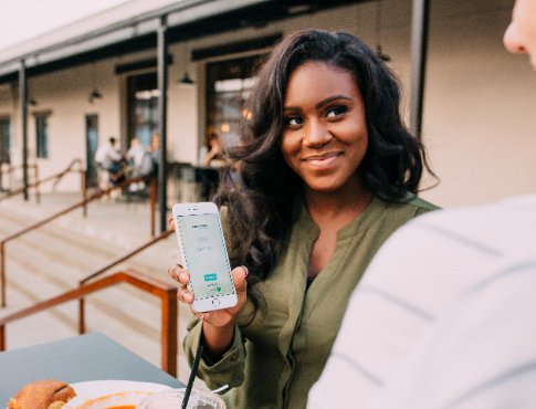 woman showing man an app on her phone