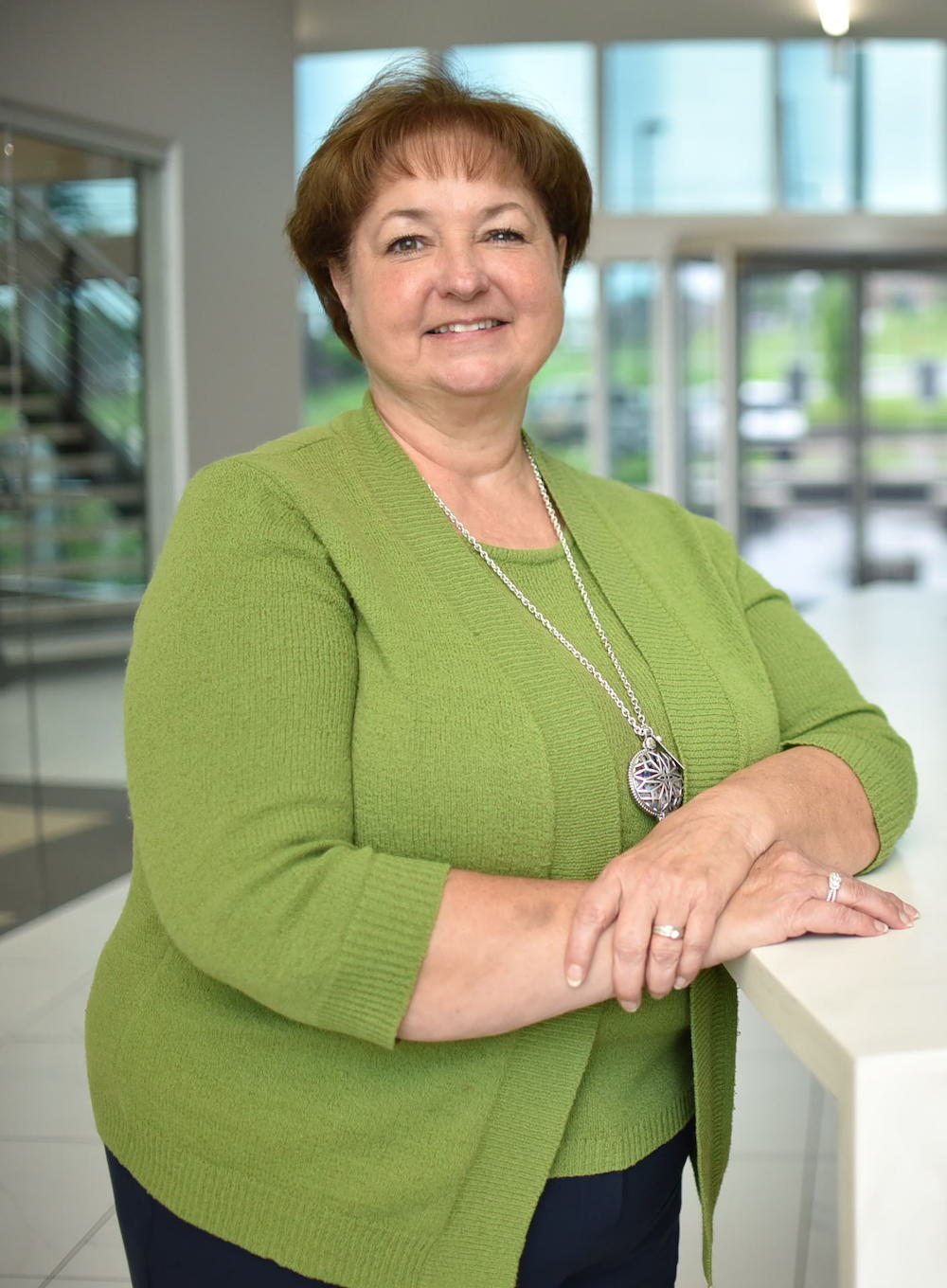 smiling woman in a green blouse